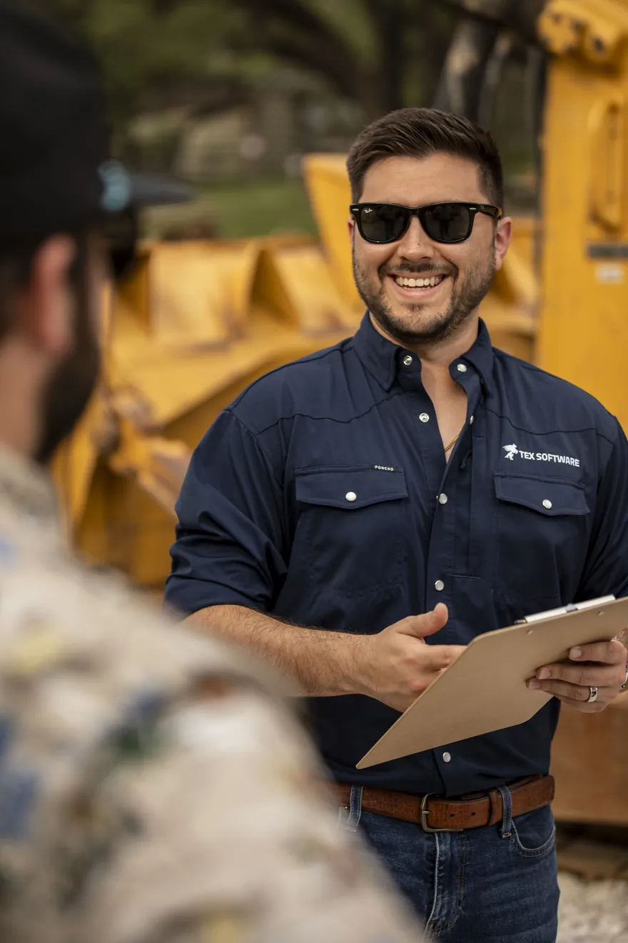 Equipment broker inspecting heavy machinery in the field